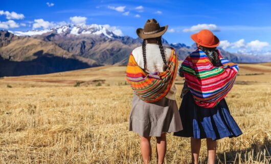 two-indigenous-women-looking-out-at-sacred-valley