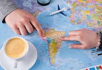 Couple planning a trip on a South America map